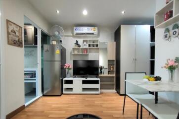 Modern living area with adjacent kitchen