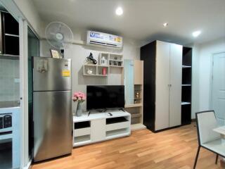 Living room with modern furniture, TV, and air conditioning