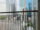 View of city buildings from a balcony