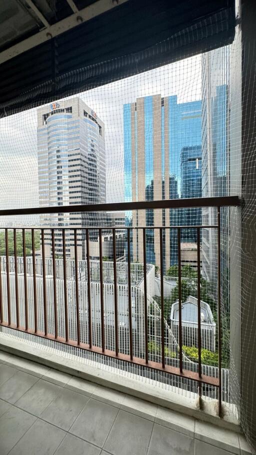 View of city buildings from a balcony