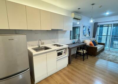 Modern living area with kitchenette and balcony