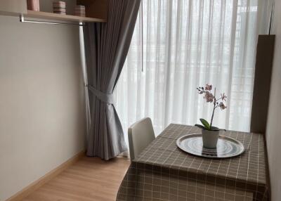 Cozy dining area with table and chairs next to a large window