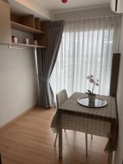 Cozy dining area with table and chairs next to a large window