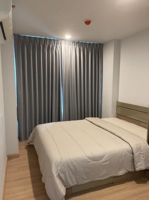 Cozy bedroom with gray curtains and a neatly made bed