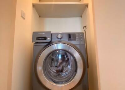 Compact laundry area with Samsung washing machine