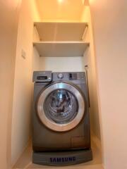 Compact laundry area with Samsung washing machine