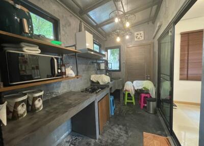 Modern industrial kitchen with open shelving and exposed concrete