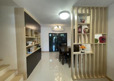 Modern dining area with built-in shelves and decor