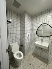 Modern bathroom with white tiled walls