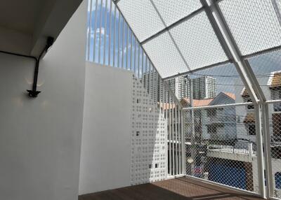 Modern balcony with wired fencing and city view