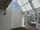 Modern balcony with wired fencing and city view