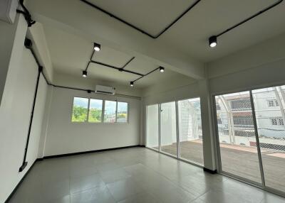 Spacious living room with modern lighting and large windows