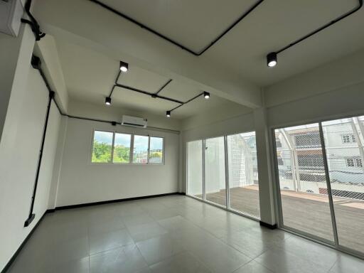 Spacious living room with modern lighting and large windows