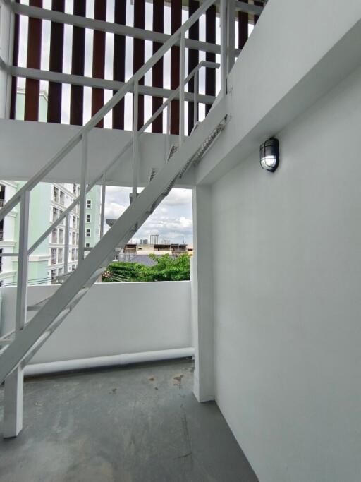 Staircase leading to upper structure with view of surrounding buildings