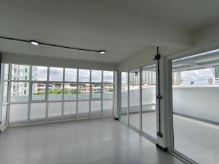 Spacious living room with large windows and access to a balcony