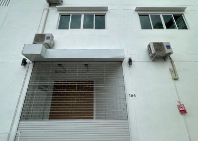 Front view of a multi-story building with air conditioning units