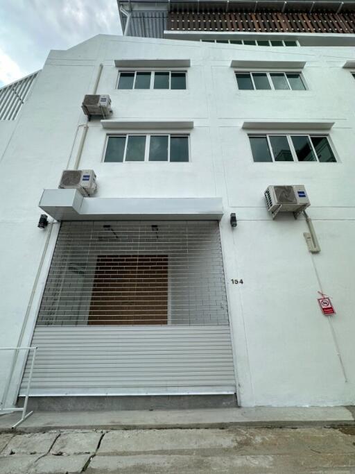 Front view of a multi-story building with air conditioning units