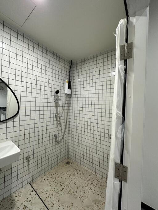 Bathroom with white tiled walls and walk-in shower