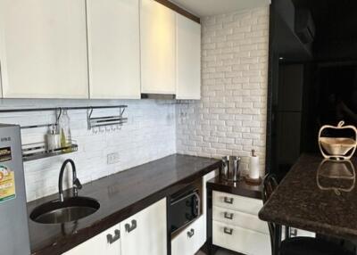 Modern kitchen with white cabinets and stainless steel appliances