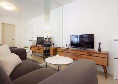 Modern living room with TV and mirrored wall