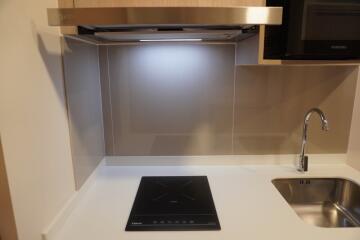 Modern kitchen with induction cooktop and stainless steel sink