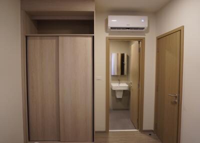 Bedroom with an ensuite bathroom featuring a french bidet and wooden built-in wardrobe