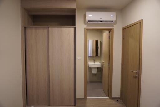 Bedroom with an ensuite bathroom featuring a french bidet and wooden built-in wardrobe