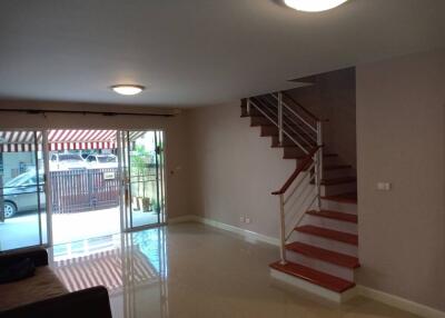 spacious living room with a view of the patio and stairs leading to the upper floor