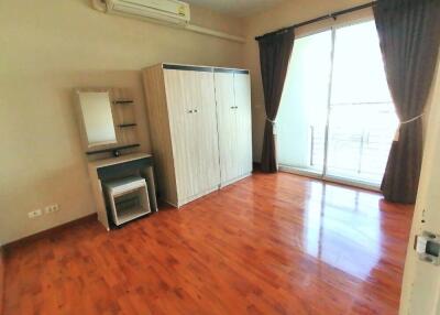 Spacious bedroom with wooden flooring