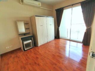 Spacious bedroom with wooden flooring