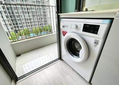 Laundry area with washing machine and outside view