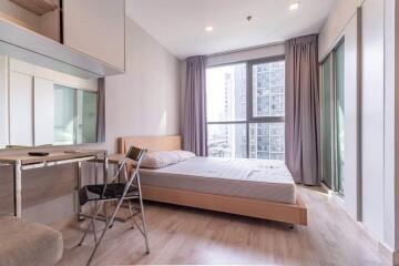 Modern bedroom with large window and natural light