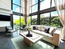 Spacious living room with large windows and garden view