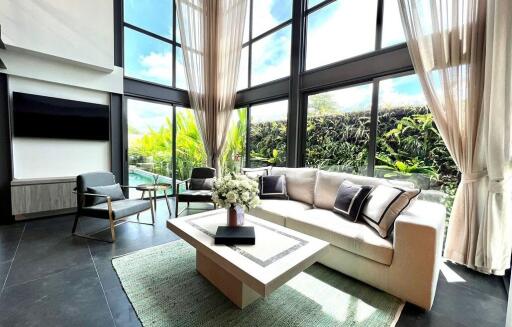 Spacious living room with large windows and garden view