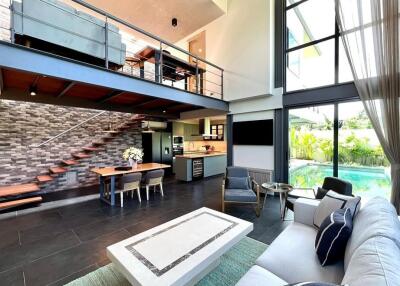 Modern living room with high ceilings and loft area