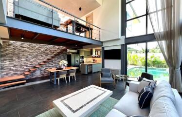 Modern living room with high ceilings and loft area