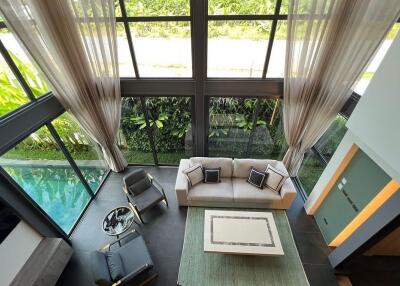 Modern living room with large windows and pool view