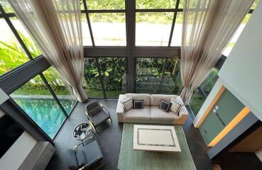 Modern living room with large windows and pool view