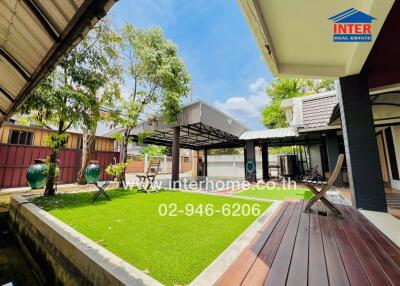 Outdoor patio with artificial grass and seating area