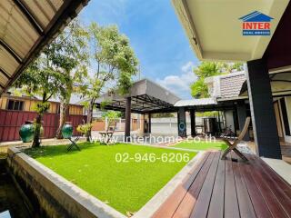 Outdoor patio with artificial grass and seating area