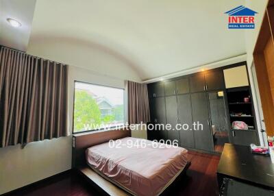 Spacious bedroom with built-in wardrobe and large window