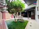 Outdoor patio area with greenery and seating