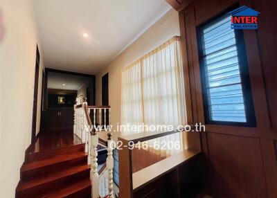 Hallway with wooden stairs and windows