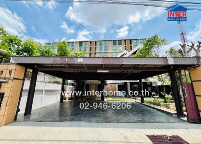 Covered parking area in front of a residential building