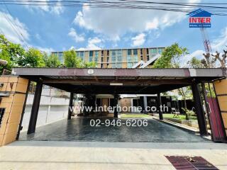 Covered parking area in front of a residential building