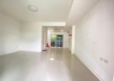 Spacious living room with tiles and sliding glass doors