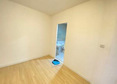 Empty bedroom with doorway to a bathroom