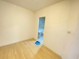 Empty bedroom with doorway to a bathroom