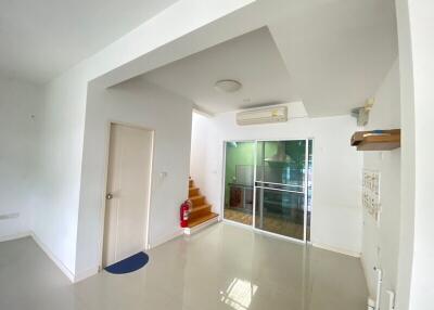 Modern living area with stairwell and glass doors