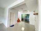 Modern living area with stairwell and glass doors